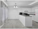 Bright eat-in kitchen features white cabinets, gray countertops, and stainless steel appliances at 2612 Kirkhill Ct, Lawrenceville, GA 30044