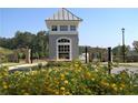 Community entrance with guardhouse, stone gate and beautiful flower beds at 1279 Lakeside Overlook, Canton, GA 30114