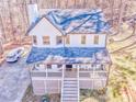 Aerial view of a white two-story home showcasing its roof, porch, and surrounding landscape at 2738 Allyn Nw Way, Kennesaw, GA 30152