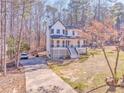 A side-angle view of a two-story home with a driveway and expansive front yard at 2738 Allyn Nw Way, Kennesaw, GA 30152