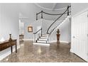 Bright foyer with a grand staircase and marble floors at 3670 River Mansion Dr, Peachtree Corners, GA 30096