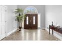 Welcoming foyer with a dark wood front door, tiled floors, and neutral paint at 3670 River Mansion Dr, Peachtree Corners, GA 30096
