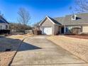 Well-maintained single Gathering home featuring an attached garage with a long, paved driveway at 905 City Park Dr, Mcdonough, GA 30252