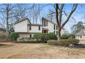 Charming two-story home with a landscaped yard and interesting architectural details at 2667 Stonebrook Ne Ct, Roswell, GA 30075