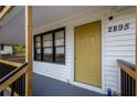 Close up of the front entrance featuring a yellow painted door, house numbers, and freshly painted trim at 2895 Akron St, Atlanta, GA 30344