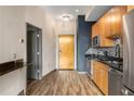 Stylish kitchen equipped with stainless steel appliances, wood cabinetry, and granite countertops at 3400 Malone Dr # 303, Atlanta, GA 30341
