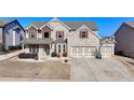Traditional two-story brick home with attached two-car garage and well-manicured lawn at 3488 In Bloom Way, Auburn, GA 30011
