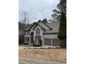 Charming two-story home with a well-maintained yard and two-car garage at 911 Laurel Crest Dr, Woodstock, GA 30189