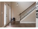 Light and airy entryway with hardwood floors and staircase with decorative iron railing at 1187 Kingston Hill Dr, Loganville, GA 30052