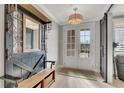 Bright entryway with a bench, decoratice mirror, and a stylish light fixture at 581 Brashy St, Woodstock, GA 30188