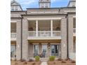 Elegant brick townhome with a covered front porch, perfect for relaxing at 581 Brashy St, Woodstock, GA 30188