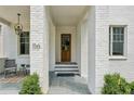 Charming front entrance with a beautiful wood door, front porch, and bluestone steps at 116 Terrace Dr, Atlanta, GA 30305