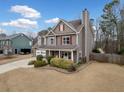 Beautiful two-story home boasts a spacious front yard, attached garage, and a classic design that complements the neighborhood at 128 Holly Pl, Canton, GA 30115