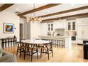 Spacious open kitchen with white cabinets, marble countertops, and hardwood floors at 20 Swann Wynd, Chattahoochee Hills, GA 30268