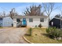 Well-maintained one-story home with blue door, green yard, and mature trees at 17 Turman #4 Se Ave, Atlanta, GA 30315