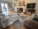 Inviting living room with hardwood floors, fireplace, and stylish neutral furniture at 25 Clay Ct, Hiram, GA 30141