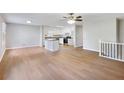 Open-concept living room and kitchen with hardwood floors and modern finishes create a bright and inviting space at 4239 Newcomb Rd, Decatur, GA 30034