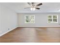 Spacious living room with new hardwood floors, neutral paint, and abundant natural light from large windows at 4239 Newcomb Rd, Decatur, GA 30034
