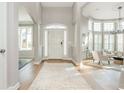 Elegant foyer with hardwood floors, transom window, and living area with bright windows at 1516 Ashford Club Ne Ct, Brookhaven, GA 30319