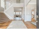 Bright foyer with hardwood floors, staircase, and views into the formal living area at 1516 Ashford Club Ne Ct, Brookhaven, GA 30319