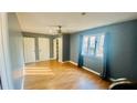 A spacious bedroom with hardwood floors, soft gray paint and a ceiling fan at 135 Windy Hill Rd, Fayetteville, GA 30214