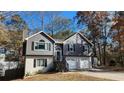 Two-story home with a two-car garage, front yard, and a storage shed in the backyard at 27 Sunrise Ct, Dallas, GA 30157