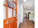 Inviting entryway with a vibrant front door, dark hardwood floors and a glimpse into the modern kitchen at 4122 Antler Se Trl, Smyrna, GA 30082
