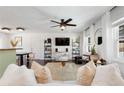 Bright living room with modern furnishings, large windows, and a stylish ceiling fan at 4122 Antler Se Trl, Smyrna, GA 30082