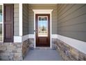 A craftsman-style front door with decorative glass, sidelights, and stone accents for enhanced curb appeal at 804 White St, Villa Rica, GA 30180