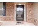 Elegant front door with glass panel and sidelights, complemented by brick facade and black shutters at 4808 Albany Way, Atlanta, GA 30331