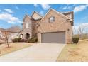 Beautiful brick home with an attached two-car garage and a spacious driveway, set against a clear blue sky at 4808 Albany Way, Atlanta, GA 30331