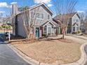 Charming two-story townhouse featuring a brick facade, gray siding, well-manicured lawn and an attached garage at 102 Johnson Ct, Decatur, GA 30030