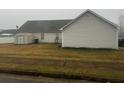 View of the backyard with vinyl siding and storage shed at 10936 Station Dr, Hampton, GA 30228