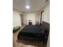 Cozy bedroom with a comfortable black bed and natural light at 10936 Station Dr, Hampton, GA 30228
