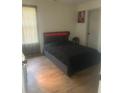 Bedroom with a modern bed frame and plenty of natural light at 10936 Station Dr, Hampton, GA 30228