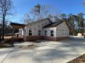 Side view of house with brick and siding construction under clear blue skies at 2515 Hogan Rd, East Point, GA 30344
