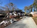 Exterior view of house with brick and siding construction, long driveway with clear skies at 2515 Hogan Rd, East Point, GA 30344