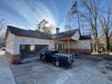 View of garage with gray pickup truck parked outside under clear blue skies at 2515 Hogan Rd, East Point, GA 30344
