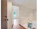 Bright entryway with hardwood floors and white staircase railing leading to a loft area at 587 Virginia Ne Ave # 315, Atlanta, GA 30306