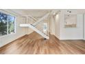 Spacious living room featuring wood floors, large window, and staircase at 587 Virginia Ne Ave # 315, Atlanta, GA 30306