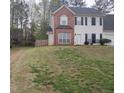 Charming two-story home features a brick and vinyl facade, well-maintained lawn, and inviting curb appeal at 12264 Crestwood Ct, Fayetteville, GA 30215