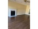 Spacious living room with hardwood floors and fireplace with white mantle at 12264 Crestwood Ct, Fayetteville, GA 30215