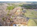 Aerial view of a 10-acre lot showing the house and surrounding mature trees at 550 Oak Ridge Dr, Oxford, GA 30054