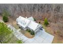Aerial view of the house showing the driveway and surrounding mature trees at 550 Oak Ridge Dr, Oxford, GA 30054