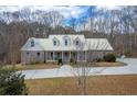 Beautiful brick home with a metal roof, dormer windows, and a large front yard at 550 Oak Ridge Dr, Oxford, GA 30054