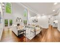 Sun-drenched living room with soaring ceilings, a cozy fireplace, hardwood floors, and stylish décor at 880 Cold Harbor Dr, Roswell, GA 30075
