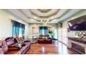Spacious living room with recessed lighting, chandelier, stone fireplace, and hardwood floors at 1724 Hill Ne St, Conyers, GA 30012