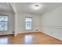 Formal dining room with classic molding, hardwood floors, neutral walls, and plenty of natural light at 2356 Sherbrooke Ne Dr, Atlanta, GA 30345