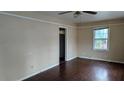 Bedroom with hardwood floors, neutral walls, and a ceiling fan for added comfort at 1210 Beech St, Marietta, GA 30062