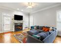 Comfortable living room with fireplace, hardwood floors, and a large sectional sofa at 1363 Summer Lane Se Dr, Atlanta, GA 30316
